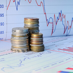 Stacks of coins with financial charts