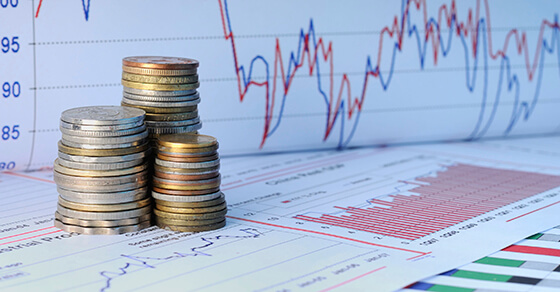 Stack of coins with financial charts for business valuations