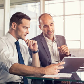 Two business men looking at a tablet