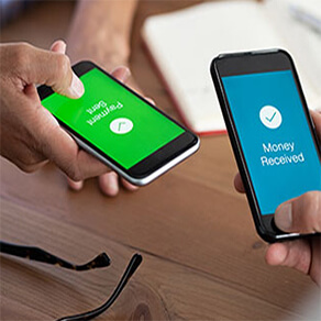 Photo of two cellular phones each being held by two different people, one with the word 