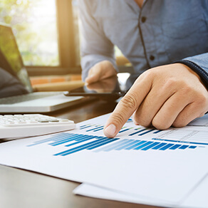 auditor or financial inspector working on sales performance report at modern workplace