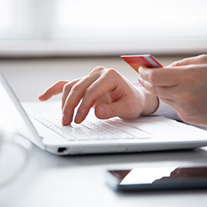 Businessman holding credit card and using laptop. Online payd.