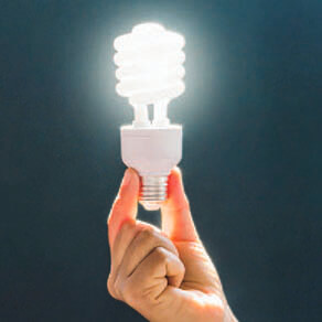 Hand holding an energy efficient lightbulb