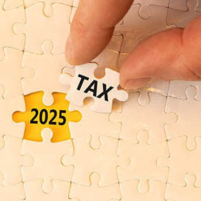 Cream colored puzzle with piece removed showing the word tax and 2025