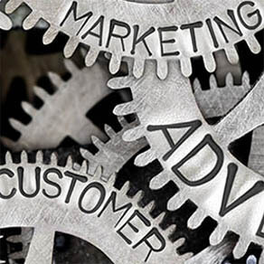 Macro photo of tooth wheel mechanism with ADVERTISING, SALES, PLAN, CREATIVITY, CUSTOMER, MARKETING concept words