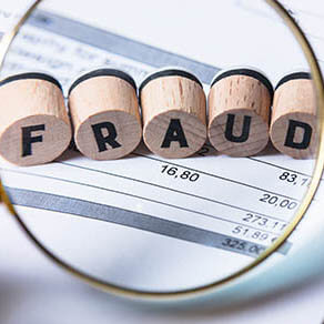 Fraud Blocks Through Magnifying Glass On Invoice