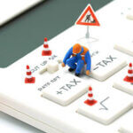 Miniature people Construction worker Keypad TAX button For tax calculation. Easy to calculate. on White calculator on white background using as background business concept and with copy space.