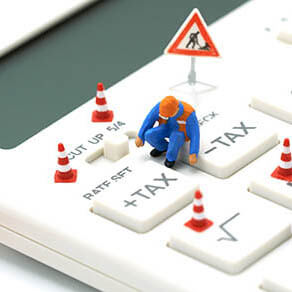 Miniature people Construction worker Keypad TAX button For tax calculation. Easy to calculate. on White calculator on white background using as background business concept and with copy space.