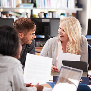Group Of College Students Collaborating On Project