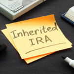 Post it notes next to a marker with the words "Inherited IRA" written on them"
