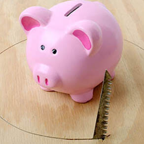 piggy bank with hole being sawed from under neath