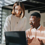 Two business collogues looking over a laptop