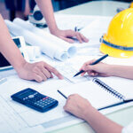 Contruction meeting reviewing documents at a desk