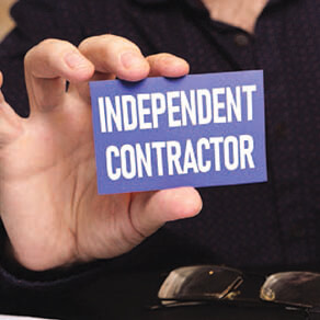 Close up of someone holding a business card reading 