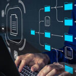 Document Management System (DMS) being setup by IT consultant working on laptop computer