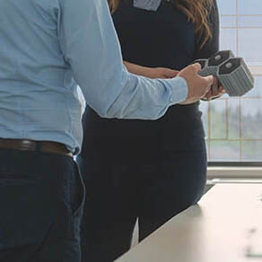 Two engineers check the model made on a 3d printer