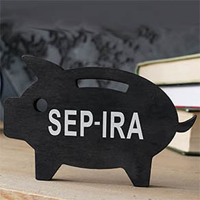 Wooden piggy bank with SEP IRA inscription on the side