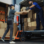 Team of Workers using a loading boxes into a delivery van